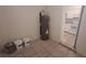 The utility room contains a water heater and leads into the kitchen at 2422 Kingsland Ave, Orlando, FL 32808