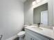 Cozy bathroom featuring a modern vanity, a toilet, and light gray walls at 2531 Sw 167Th Loop, Ocala, FL 34473