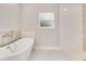 Sleek bathroom features a modern soaking tub and a walk-in shower at 2531 Sw 167Th Loop, Ocala, FL 34473