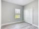Well-lit bedroom features light gray walls, a window, and a closet with bi-fold doors at 2531 Sw 167Th Loop, Ocala, FL 34473