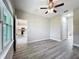 Neutral bedroom featuring a ceiling fan, large window and door leading to the kitchen at 2531 Sw 167Th Loop, Ocala, FL 34473