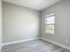 Well-lit bedroom with wood-look floors and a window offering a pleasant view at 2531 Sw 167Th Loop, Ocala, FL 34473