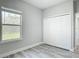 Bright bedroom with a large window, neutral walls, and a closet with folding doors at 2531 Sw 167Th Loop, Ocala, FL 34473