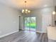 Bright dining area featuring a modern chandelier and sliding glass doors to the backyard at 2531 Sw 167Th Loop, Ocala, FL 34473