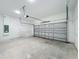 Bright garage with a concrete floor, block walls, overhead lighting, and a garage door at 2531 Sw 167Th Loop, Ocala, FL 34473
