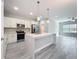 Modern kitchen featuring stainless steel appliances, a center island with sink and stylish gray flooring at 2531 Sw 167Th Loop, Ocala, FL 34473