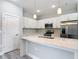 Bright kitchen with white cabinetry, stone countertops, stainless steel appliances, and a center island at 2531 Sw 167Th Loop, Ocala, FL 34473