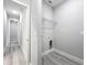 Laundry room with gray walls and floors, laundry hook ups and wire shelving at 2531 Sw 167Th Loop, Ocala, FL 34473
