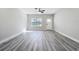 Spacious living room with a ceiling fan, a bright window and white door at 2531 Sw 167Th Loop, Ocala, FL 34473