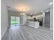 Open-concept living space combining kitchen, living room, and outdoor access at 2531 Sw 167Th Loop, Ocala, FL 34473