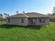 Back of home with a large yard, several windows and a covered patio at 2531 Sw 167Th Loop, Ocala, FL 34473