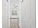 Bright bedroom featuring light wood floors, a ceiling fan, and a window with blinds at 2593 Sw 153Rd Ln, Ocala, FL 34473