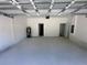 Spacious two-car garage with ample room for parking and storage, with white walls and painted floors at 2593 Sw 153Rd Ln, Ocala, FL 34473