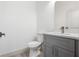 Powder room featuring a modern vanity with stone countertop, gray cabinet and chrome faucet at 2593 Sw 153Rd Ln, Ocala, FL 34473