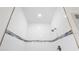 Detail of an all-tile shower with decorative accent tile and chrome shower head at 2593 Sw 153Rd Ln, Ocala, FL 34473