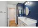 Bathroom featuring a vanity with a solid surface countertop and open doorway to other parts of home at 26609 Bull Run, Leesburg, FL 34748