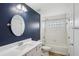 Bathroom featuring a vanity with a solid surface countertop and a tub/shower combo with tile surround at 26609 Bull Run, Leesburg, FL 34748