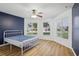 Bright, airy bedroom with wood floors, and three large windows at 26609 Bull Run, Leesburg, FL 34748