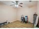 A bedroom features light walls, wood laminate flooring, and a ceiling fan at 26609 Bull Run, Leesburg, FL 34748