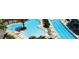 Aerial view of community pool area with ample lounge chairs and shaded spots for relaxation at 26609 Bull Run, Leesburg, FL 34748
