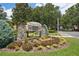 Arlington Ridge community entrance sign surrounded by vibrant landscaping and shrubbery at 26609 Bull Run, Leesburg, FL 34748