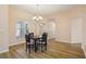 Elegant dining room with hardwood floors, modern lighting, and a view into the spacious living area at 26609 Bull Run, Leesburg, FL 34748