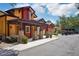 A vibrant row of buildings with stone accents and wooden pergolas creating a charming street view at 26609 Bull Run, Leesburg, FL 34748