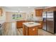 Modern kitchen featuring an island, stainless steel appliances, and open layout connecting to living area at 26609 Bull Run, Leesburg, FL 34748