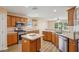 Modern kitchen with stainless steel appliances, island, and wood floors at 26609 Bull Run, Leesburg, FL 34748