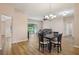 Spacious living and dining area featuring hardwood floors, access to the backyard, and neutral decor at 26609 Bull Run, Leesburg, FL 34748