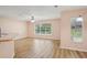 Open living area featuring hardwood floors, a large window with natural light, and neutral paint at 26609 Bull Run, Leesburg, FL 34748