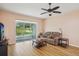 Cozy living room featuring hardwood floors, neutral paint, and access to an outdoor patio at 26609 Bull Run, Leesburg, FL 34748