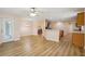 Spacious open-concept living room with wood floors, ceiling fan, and access to kitchen and dining areas at 26609 Bull Run, Leesburg, FL 34748