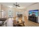 Open-concept living and dining area featuring hardwood floors, modern lighting, and sliding doors to the backyard at 26609 Bull Run, Leesburg, FL 34748