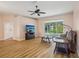 Bright living room featuring hardwood floors, neutral paint, and natural light from sliding glass doors to the patio at 26609 Bull Run, Leesburg, FL 34748