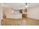 Open living room and kitchen area featuring wood floors and stainless steel appliances at 26609 Bull Run, Leesburg, FL 34748