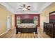 Large main bedroom with wood floors, trey ceiling, fan, and en-suite bathroom at 26609 Bull Run, Leesburg, FL 34748