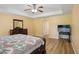 Bright main bedroom featuring wood floors, ceiling fan, and ensuite bathroom access at 26609 Bull Run, Leesburg, FL 34748