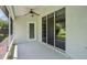 Enclosed patio with ceiling fan and sliding glass doors leading to the backyard offering space to relax and unwind at 26609 Bull Run, Leesburg, FL 34748