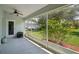 Screened-in patio with ceiling fan and view of the landscaped backyard with flowering bushes and room for seating at 26609 Bull Run, Leesburg, FL 34748