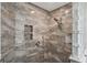 An elegant stand up shower showcasing marble tile surround, glass block accents, and modern fixtures at 26609 Bull Run, Leesburg, FL 34748