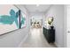 Elegant foyer featuring a long hallway with modern decor, artwork, and views of the living area at 2681 Ginseng Ivy St, Apopka, FL 32703