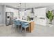 Modern kitchen with stainless steel appliances, a spacious island, and stylish barstool seating at 2681 Ginseng Ivy St, Apopka, FL 32703