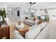 Bright, open-concept living room with tile floors, modern furnishings, and an adjacent kitchen at 2681 Ginseng Ivy St, Apopka, FL 32703