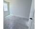 A cozy bedroom featuring a large window and a door frame at 30112 Misty Pines Rd, Mount Dora, FL 32757