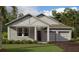 Charming one story home with a covered front porch, two-car garage, and well-maintained lawn at 30112 Misty Pines Rd, Mount Dora, FL 32757
