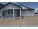 Newly built home with a two-car garage, covered porch, and light-colored exterior at 30112 Misty Pines Rd, Mount Dora, FL 32757