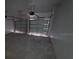 Open garage with two garage doors, automatic door openers, concrete floor and white walls ready for parking cars at 30112 Misty Pines Rd, Mount Dora, FL 32757