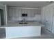 Modern kitchen with a spacious island, gray cabinets, and stainless steel appliances at 30112 Misty Pines Rd, Mount Dora, FL 32757