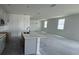 Bright open-concept kitchen with a large island, gray cabinets, stainless appliances, and plenty of natural light at 30112 Misty Pines Rd, Mount Dora, FL 32757